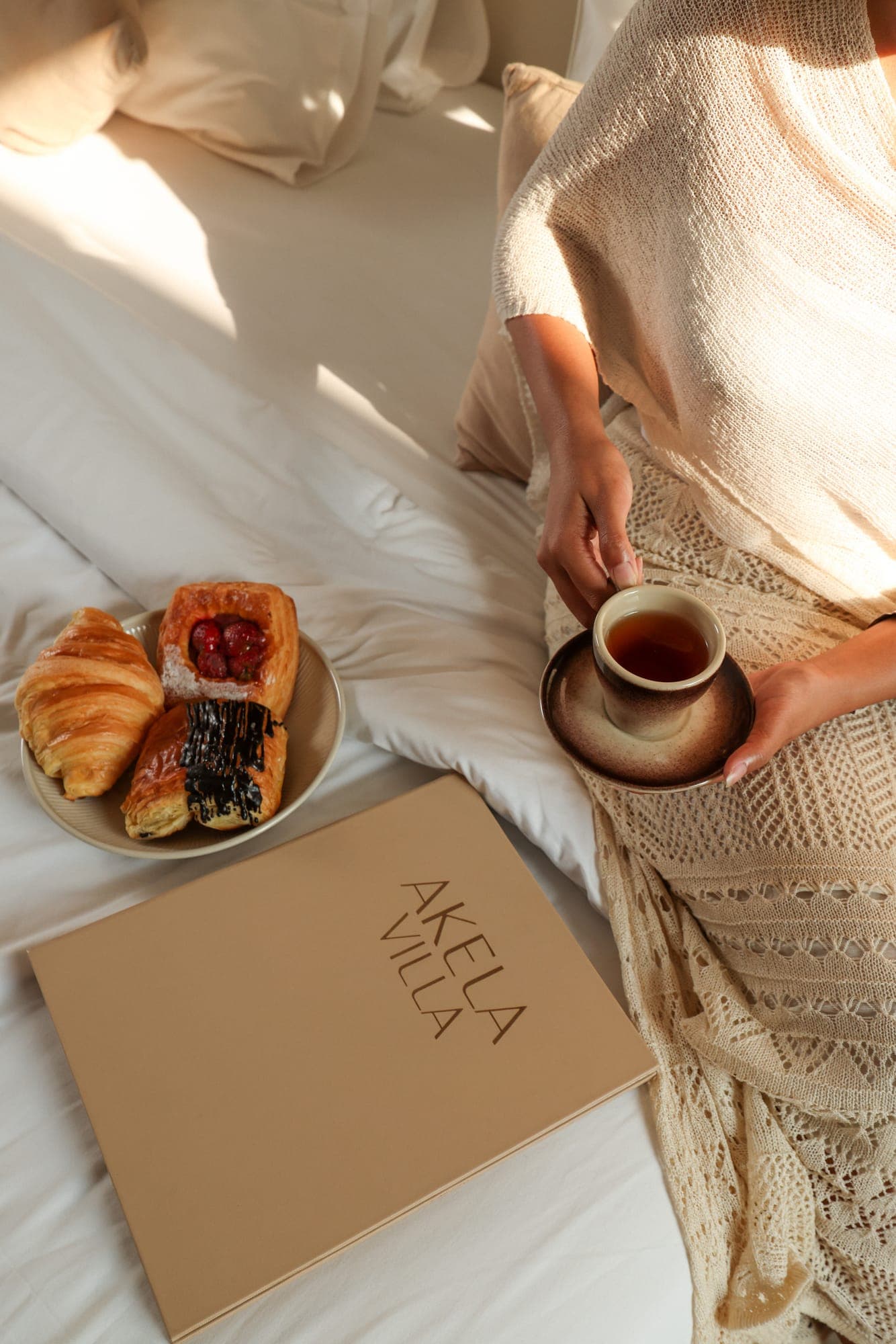 Coffee and croissants on a breakfast tray in bed