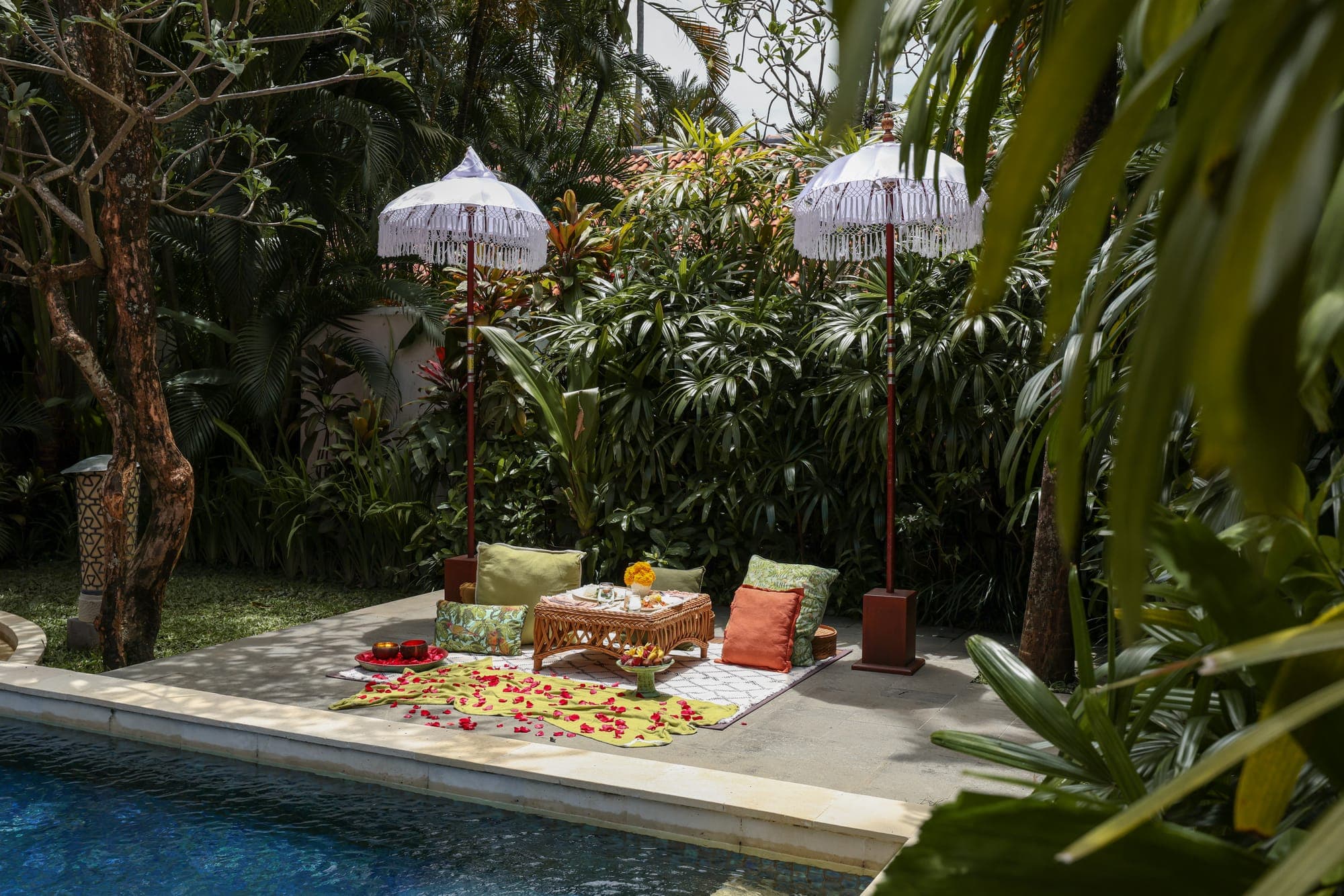 A poolside picnic under white parasols at Alaya