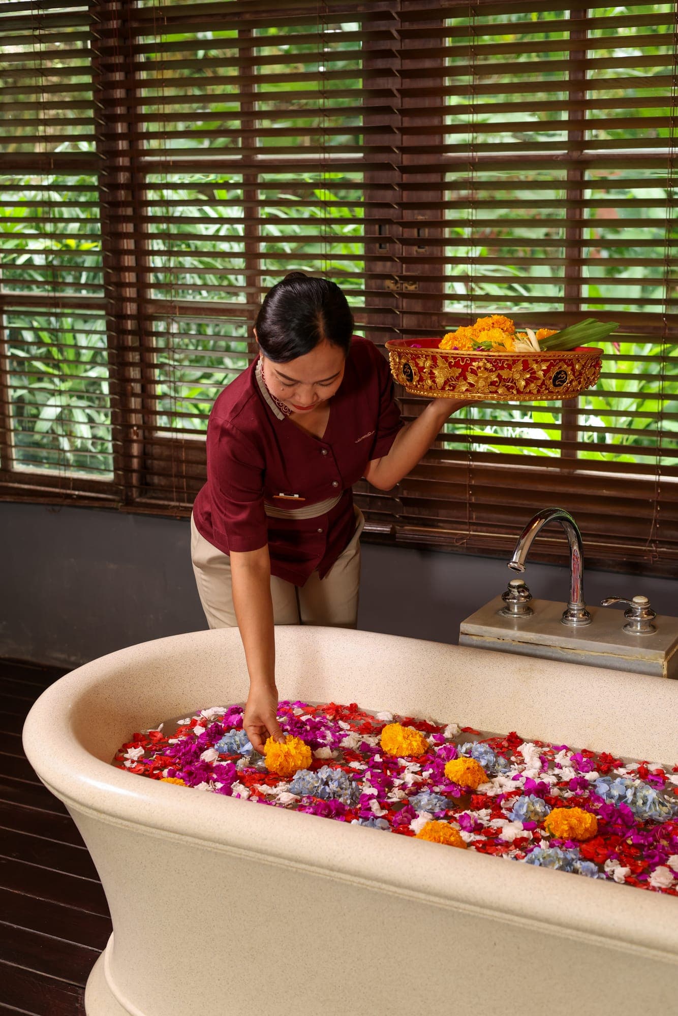 A therapist preparing a flower bath
