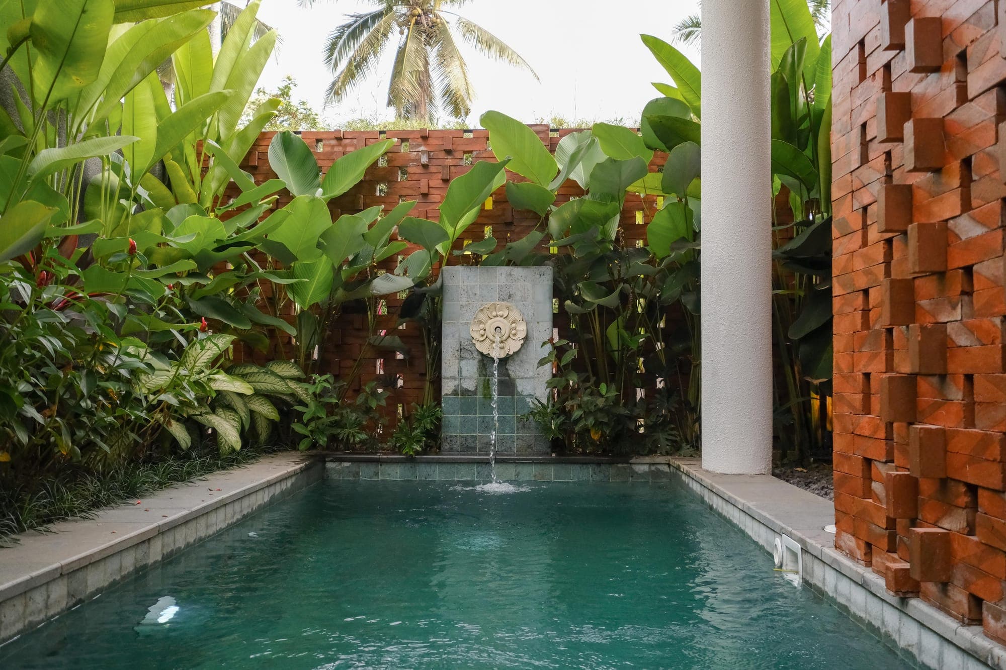 A plunge pool with a stone fountain