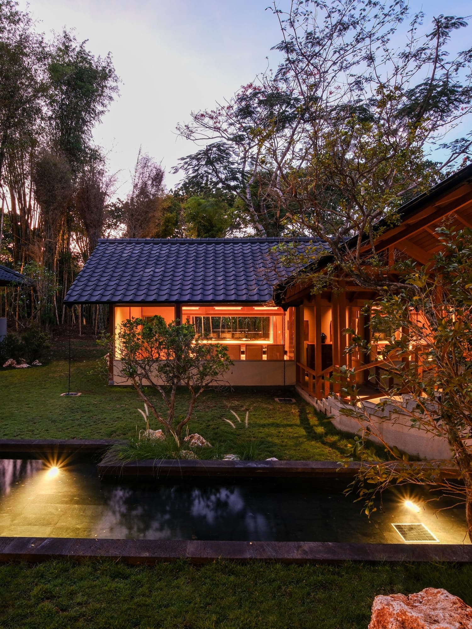 A Japanese dining pavilion glowing at dusk