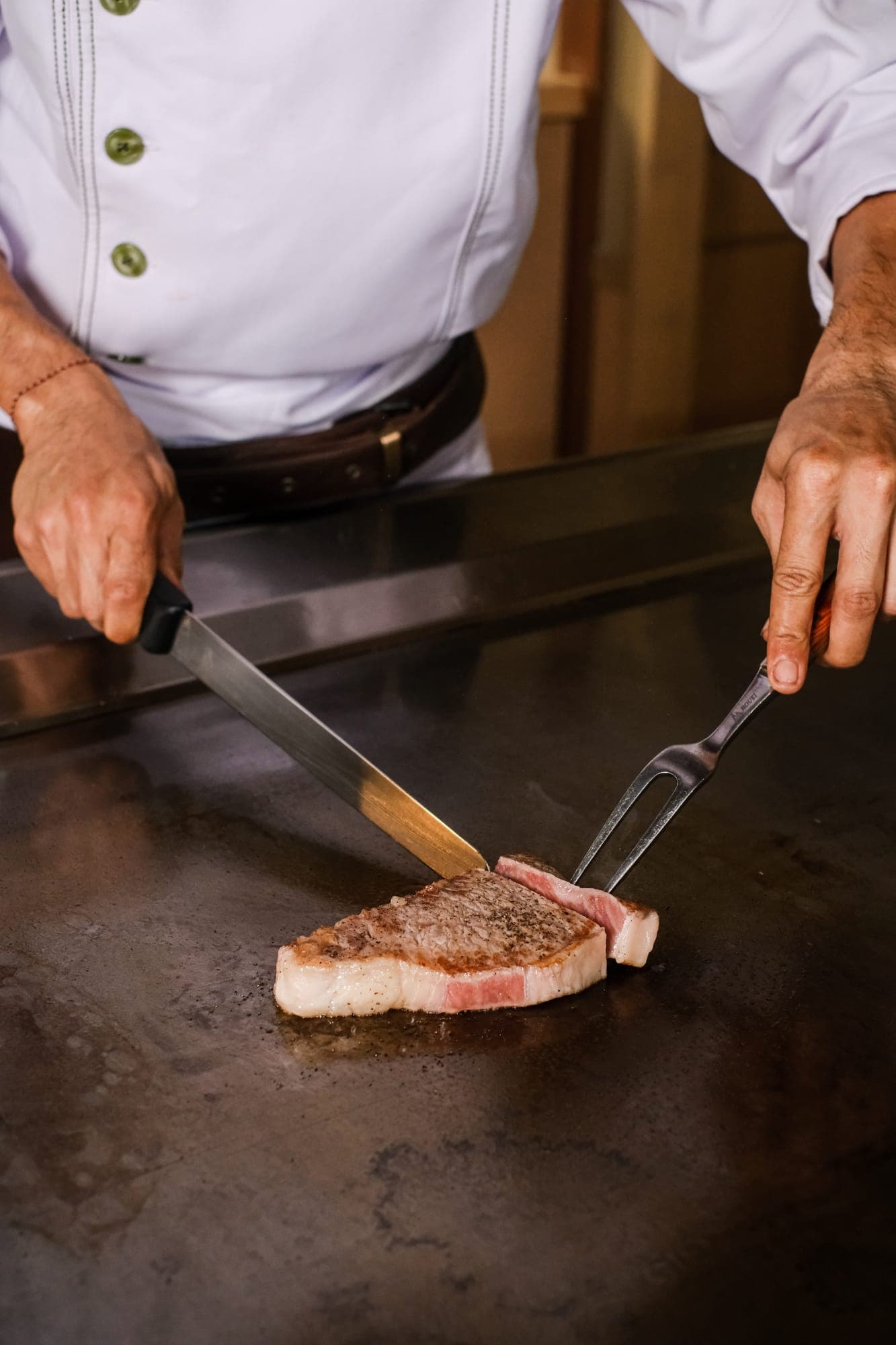 Wagyu being cut on the teppanyaki grill