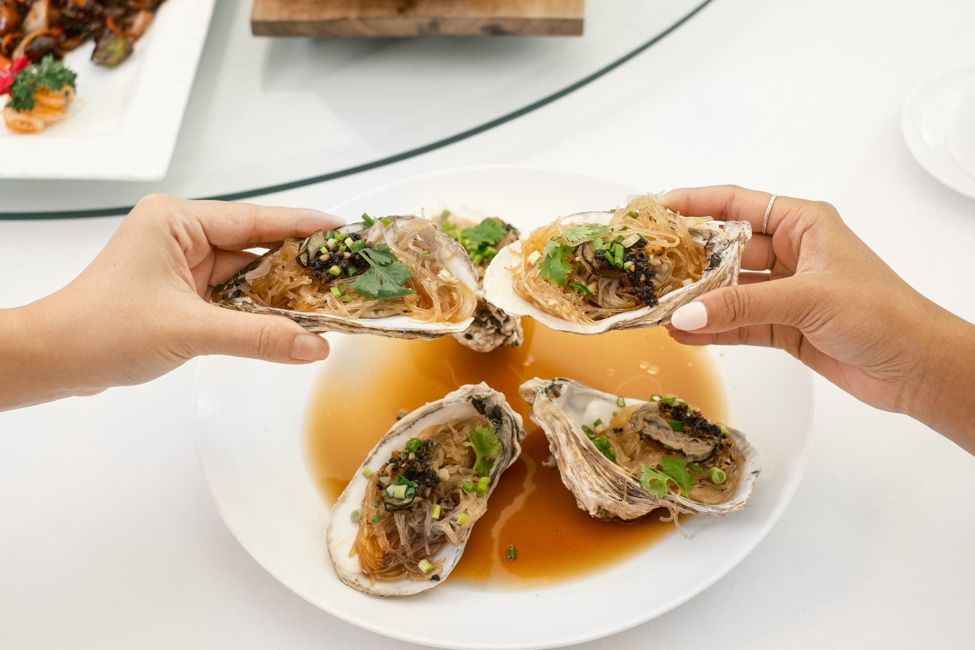 Steamed oysters being shared at the table