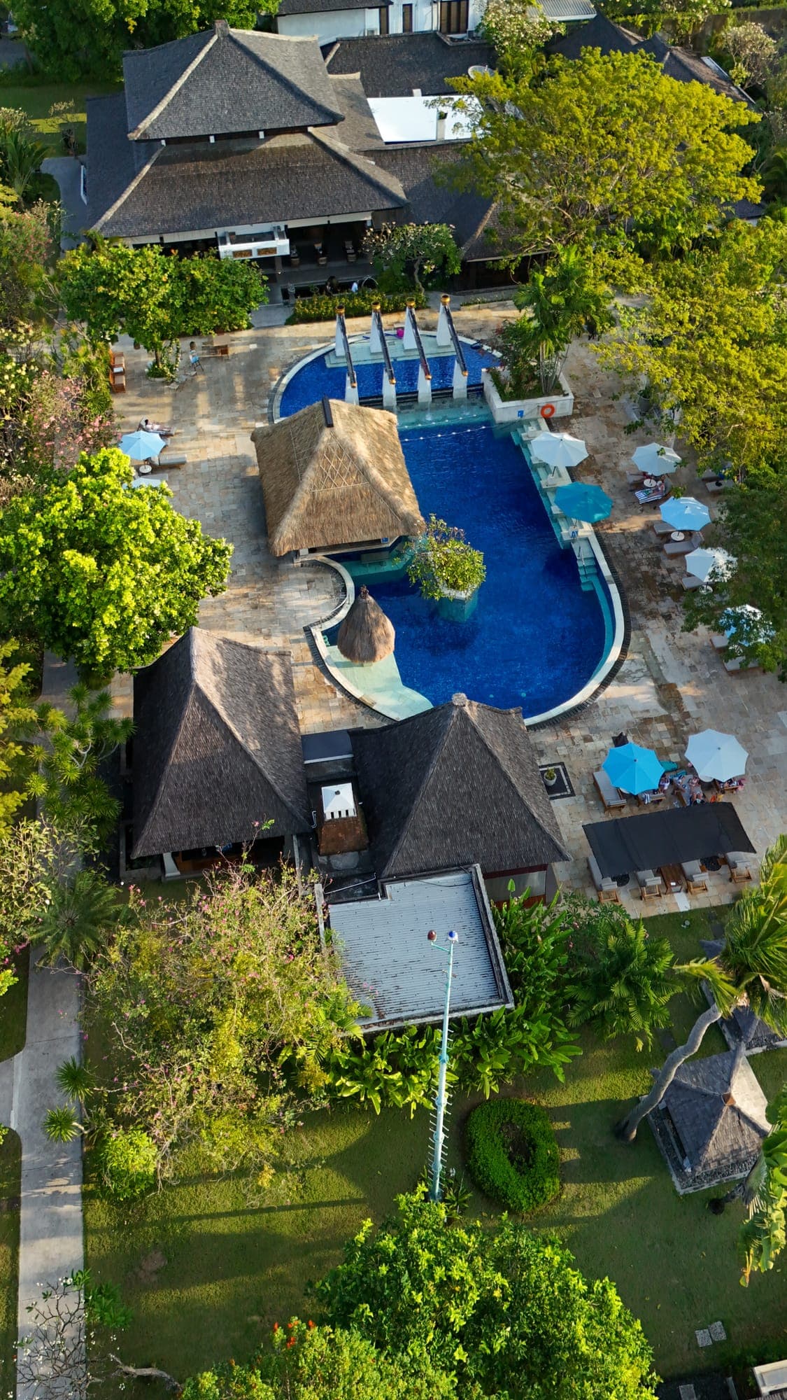 Aerial view of the resort pool and thatched pavilions