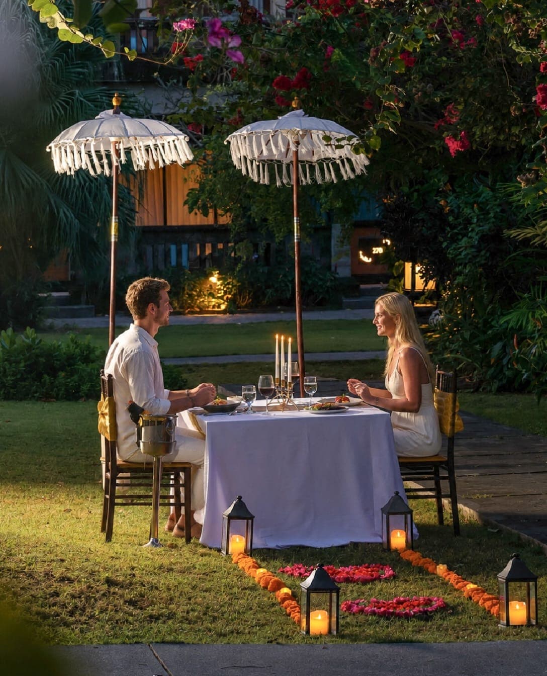 A candlelit dinner for two in a tropical garden