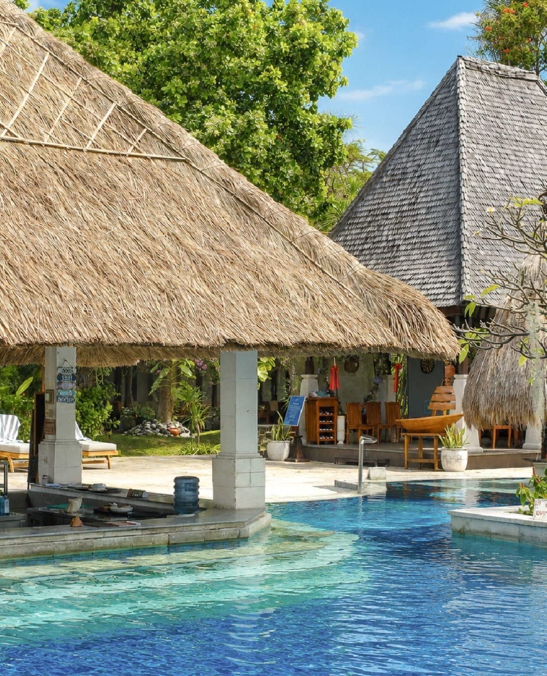 A pool bar under a thatched roof at Rama Beach Resort