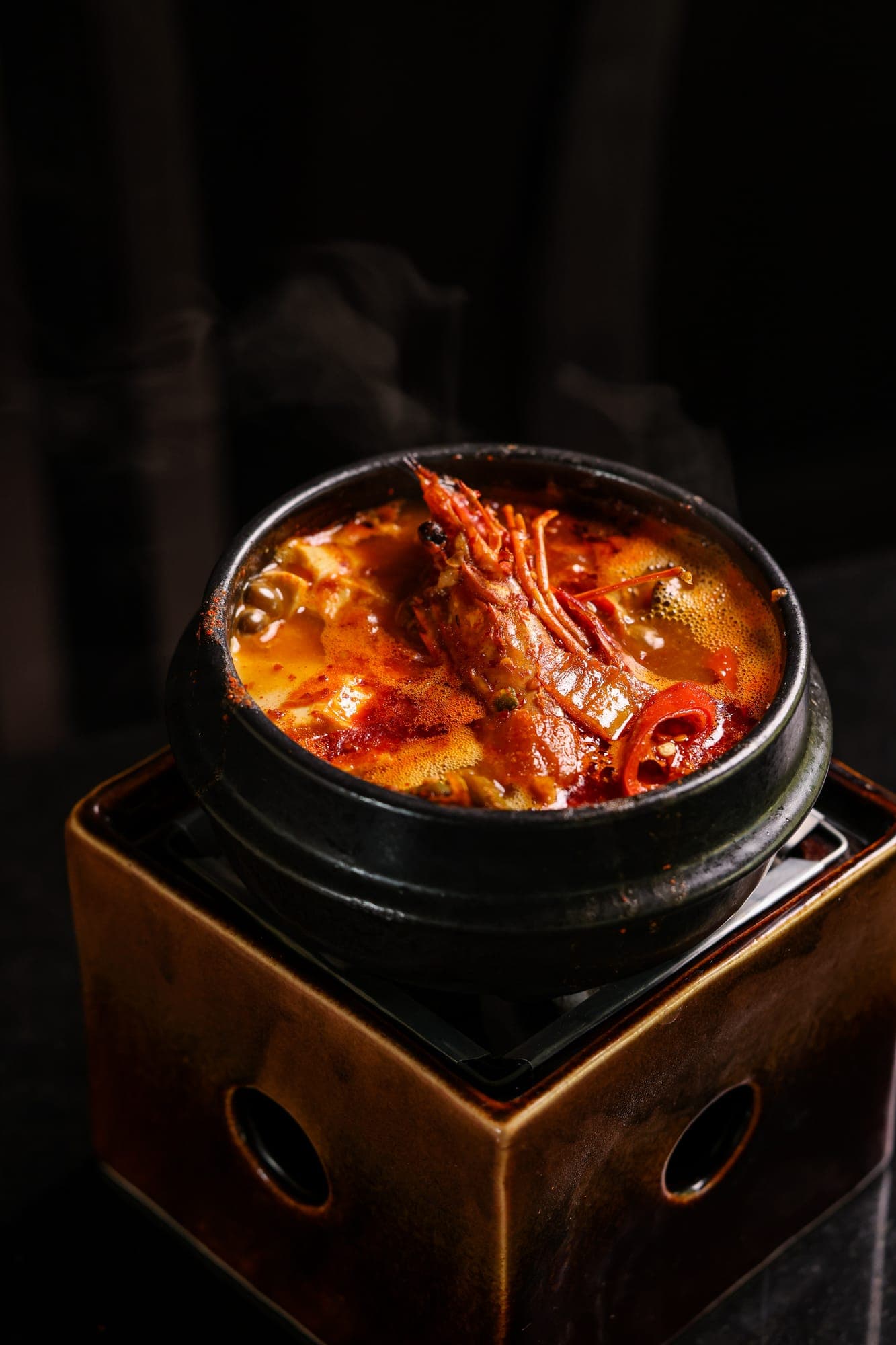Bubbling kimchi jjigae in a stone pot