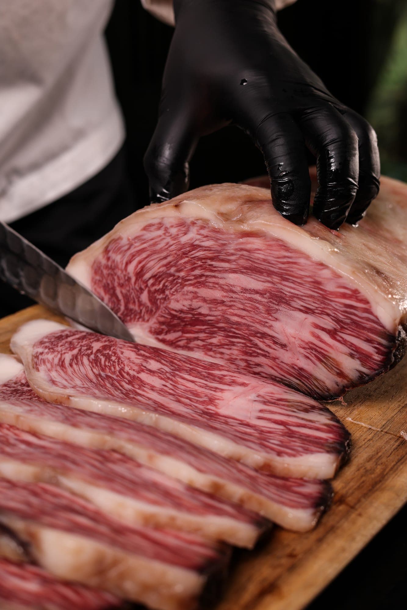 A knife cutting through marbled wagyu