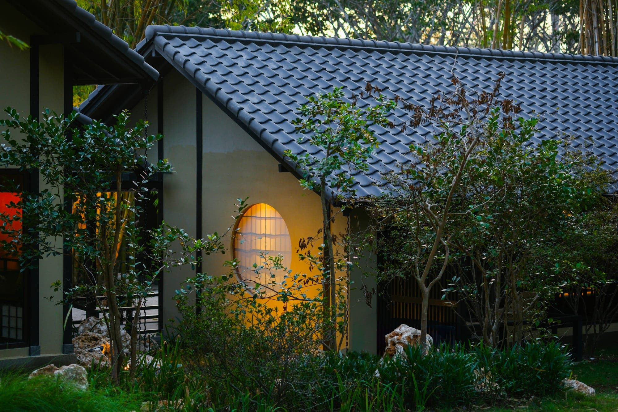 The restaurant's round lantern window at dusk