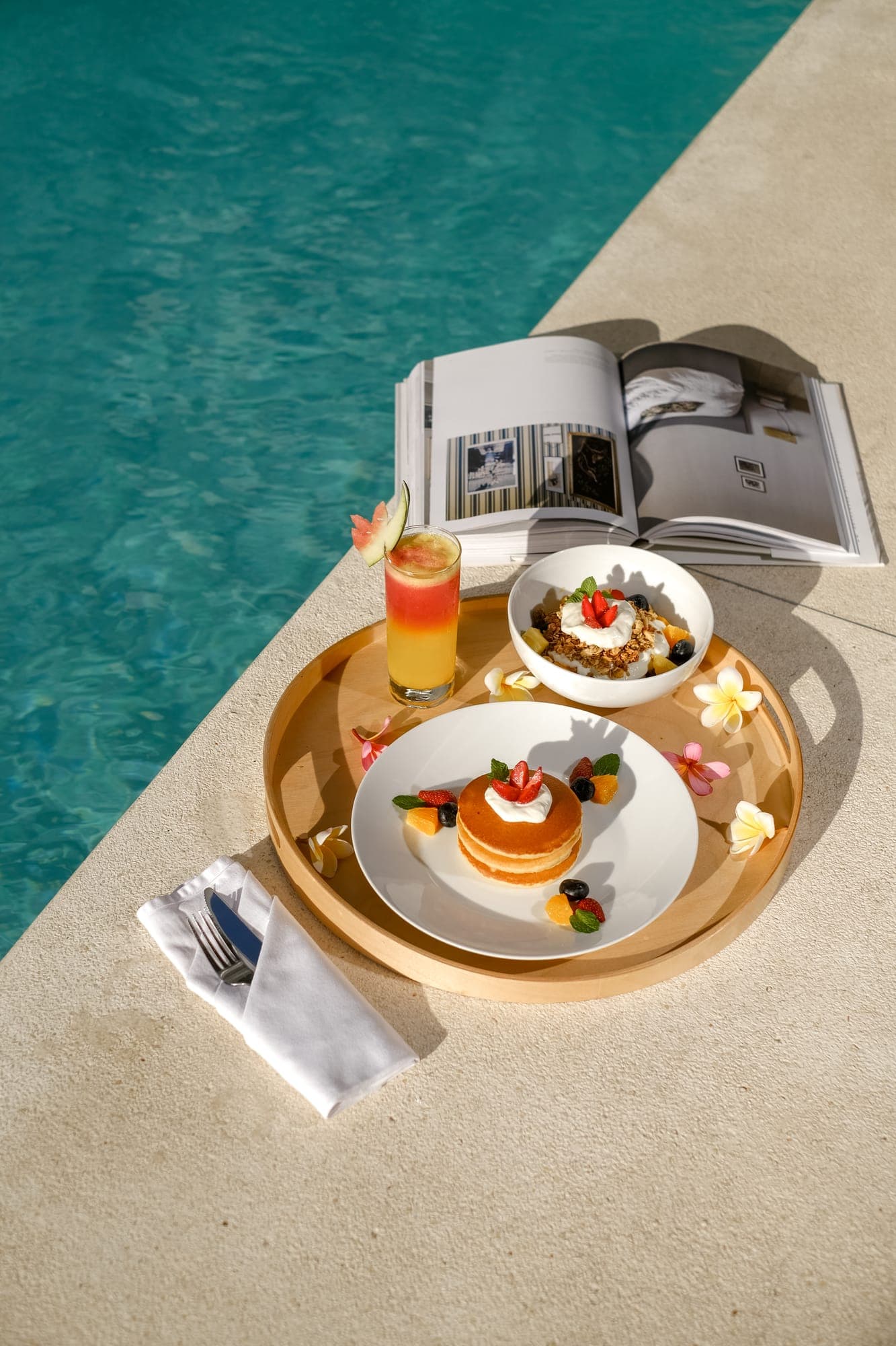 A breakfast tray beside the pool