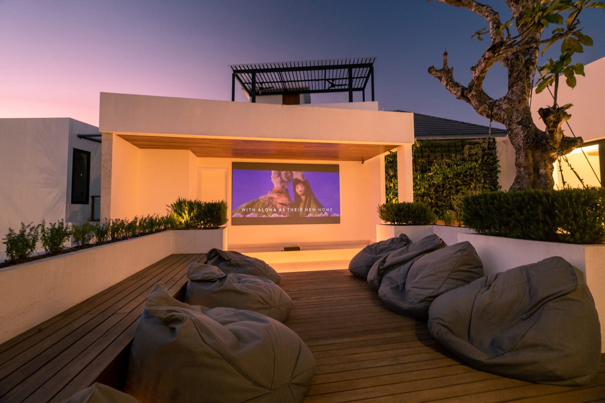 A rooftop cinema set up at sunset