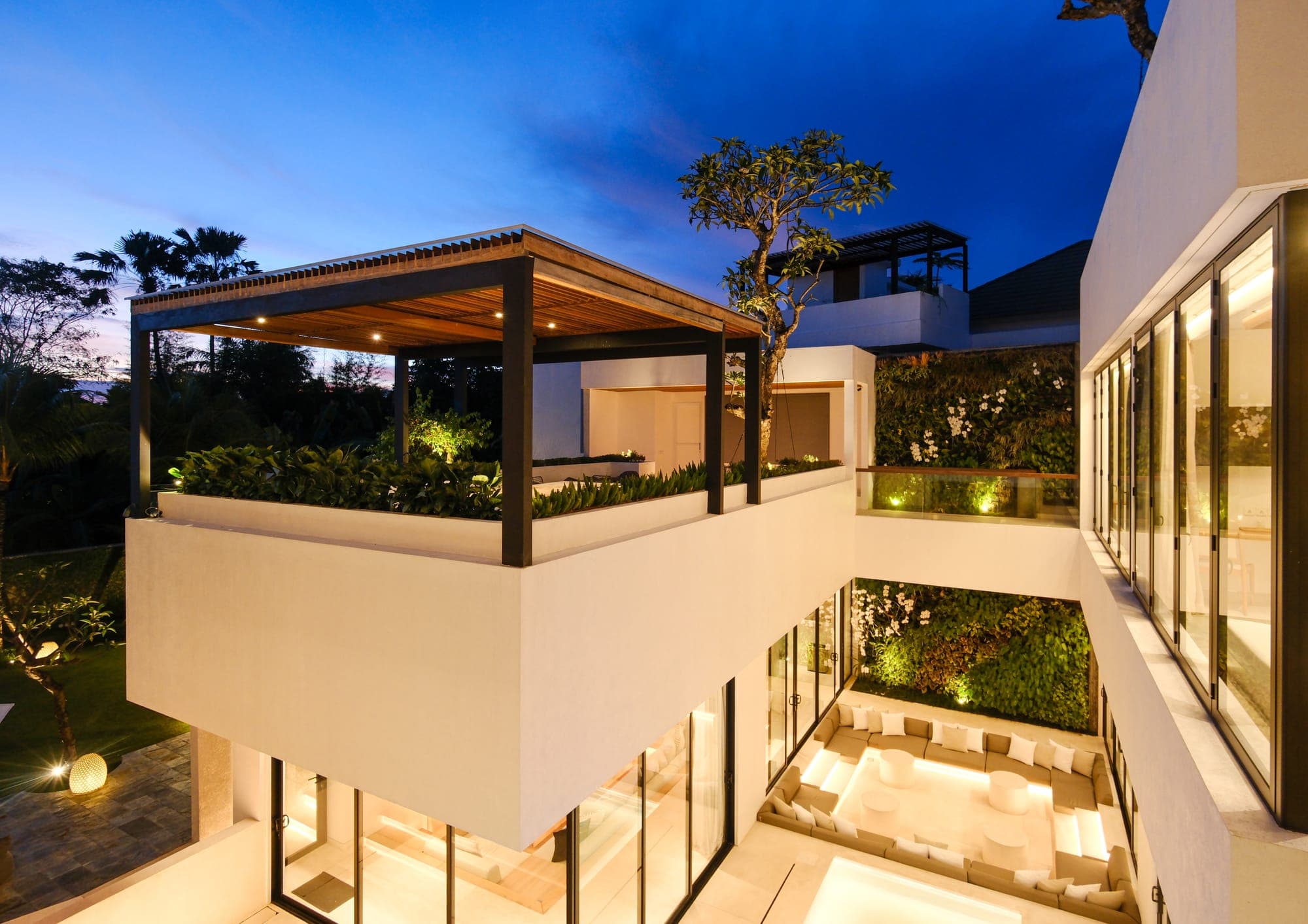 The villa lit up at dusk