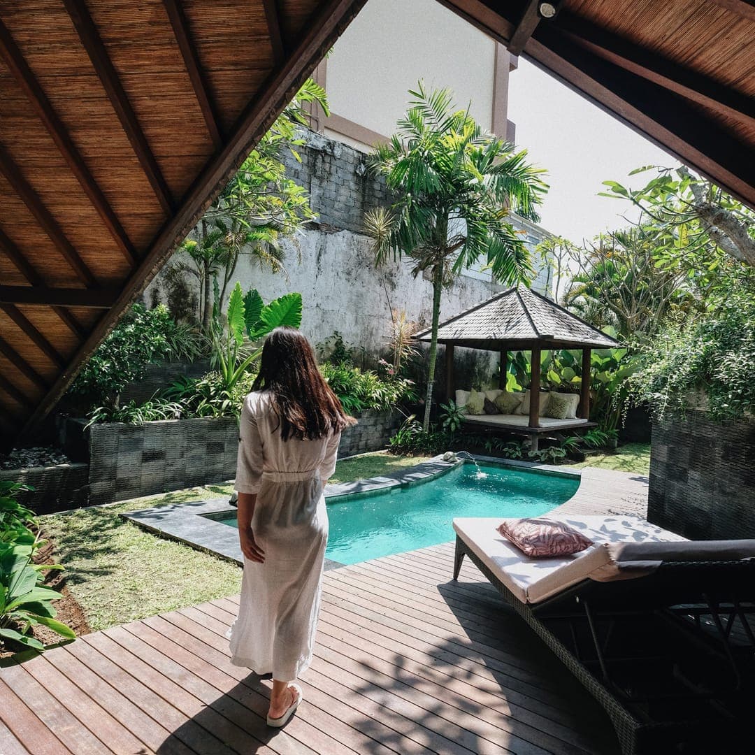 A guest walking to a private villa pool