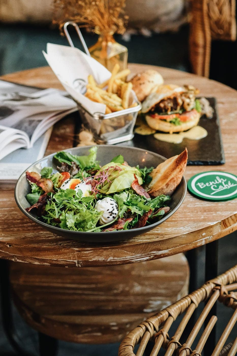 A salad and burger on a café table