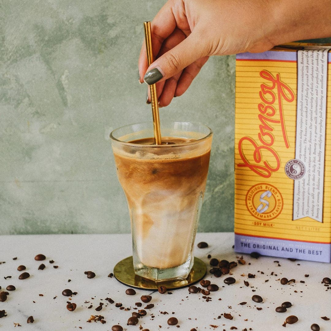 An iced coffee being stirred