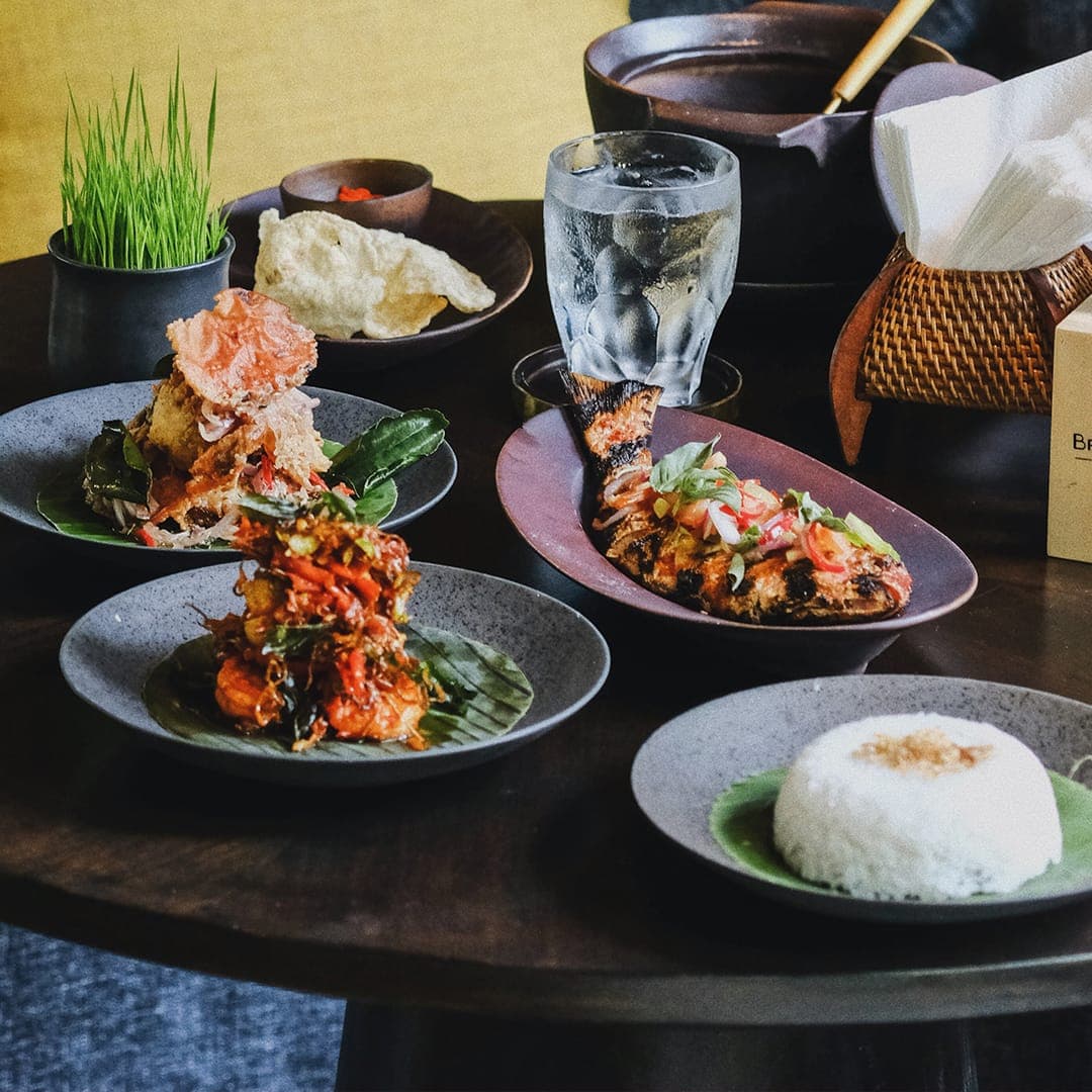 Balinese dishes set on a dark table