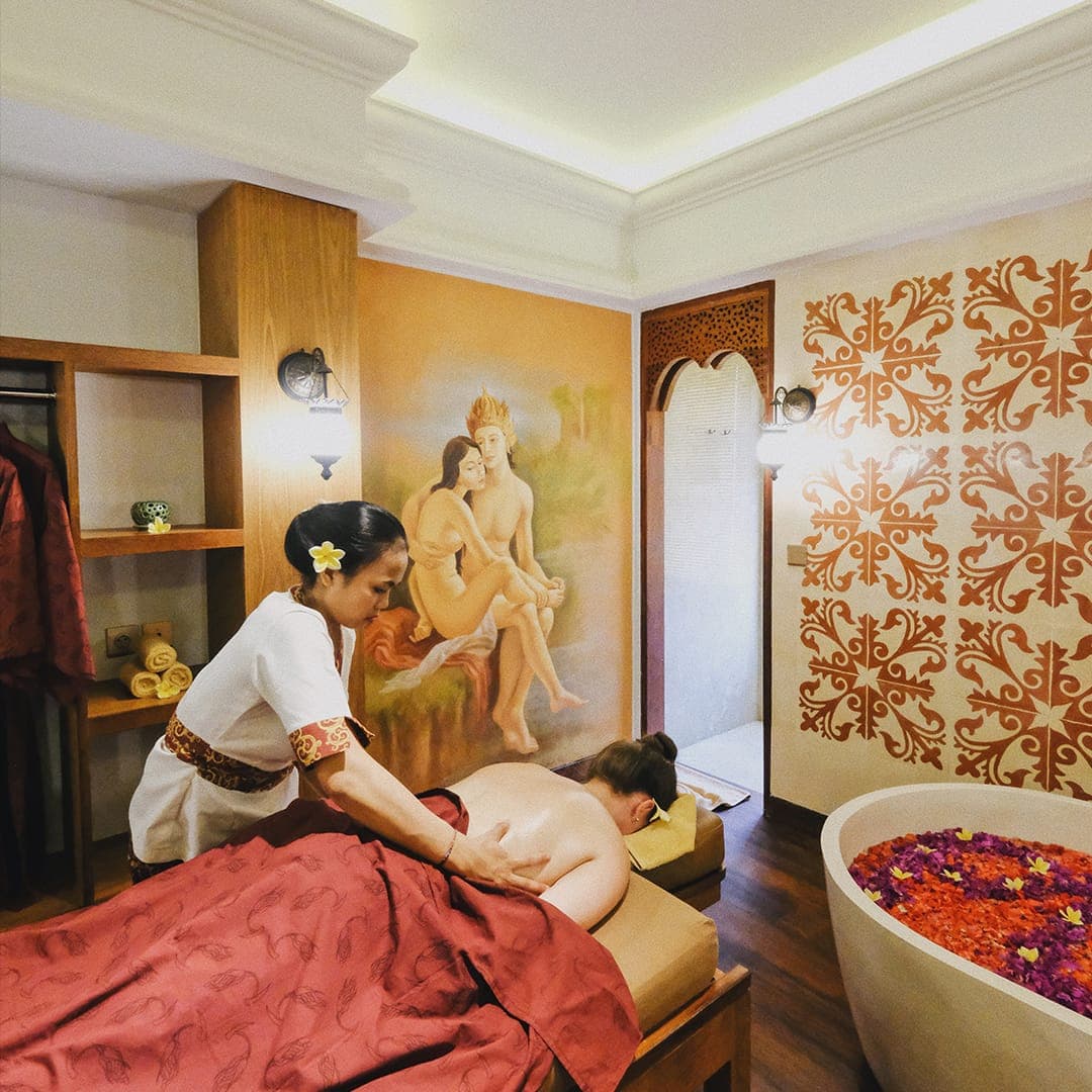 A massage beside a petal bath