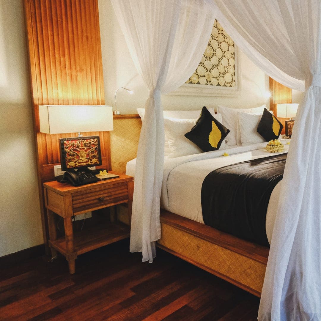 A canopy bed in a warmly lit suite